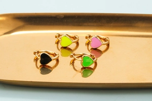Golden hoop earrings with colorful heart enamel charms in black yellow pink and green