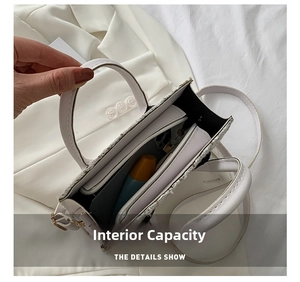 Detailed interior view of the white tweed crossbody bag showing the main storage compartment