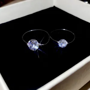 Floating zircon rings set with invisible band and round brilliant cut sparkling stones