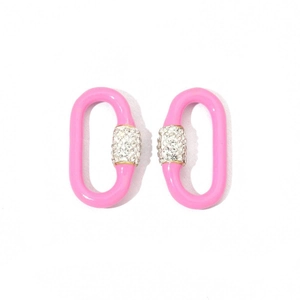 Macro shot of pink oval link earrings featuring sparkling crystal encrusted metal rings