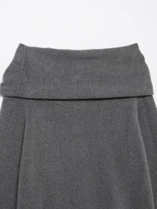 Detail of grey off-shoulder knitted sweater with textured wool blend and metal trim