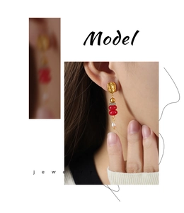 Detail of bohemian drop earrings with natural stone beads and elegant freshwater pearl