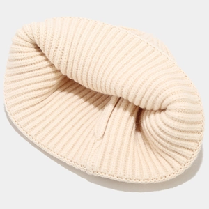Detailed close-up showing the premium ribbed knit texture and soft cream fabric of the beanie