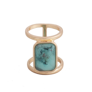 Detail view of a bohemian gold double-band ring with rectangular turquoise stone