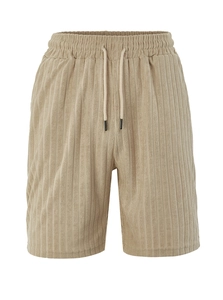 Close-up of khaki corduroy shorts showing elastic drawstring waist and vertical texture