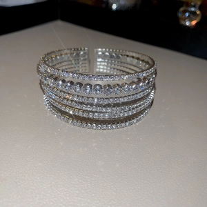 Detail of layered silver zircon cuff bracelet featuring multi-row sparkling stones