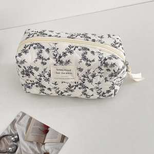 Floral quilted cotton makeup bag in black and white with zipper closure