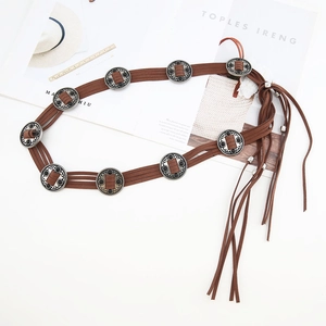 Detail of brown suede bohemian belt with vintage silver buckles and long tassel fringe