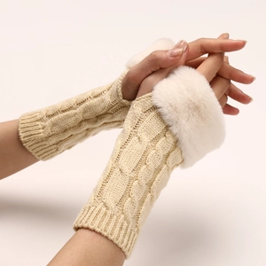 Detail of cable knit warm arm warmer with white faux fur trim in beige color