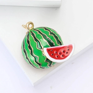 Round watermelon enamel brooch with gold-plated metal edges on white geometric stand