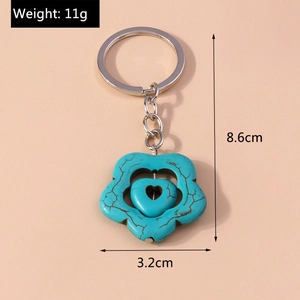 Detail view of turquoise heart keychain measuring 8.6cm by 3.2cm and weighing 11g