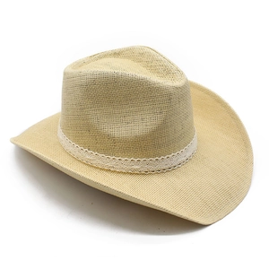Detailed texture of beige woven straw cowboy hat with delicate white crochet lace band