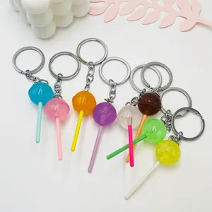 Luminous acrylic lollipop keychains in eight colors with metal rings on white background