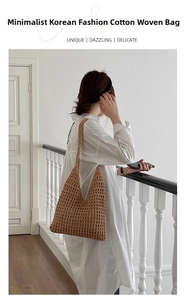 Close-up of brown hollow cotton crochet tote bag worn by model in soft indoor lighting