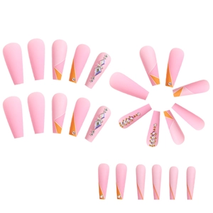 Detail of pink matte long coffin fake nails with geometric patterns and sparkling rhinestones