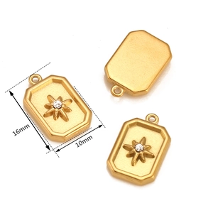 Macro view of gold 18k plated rectangular starburst pendant with dimensions 16x10mm