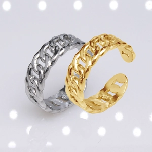 Macro detail of adjustable silver and gold chain rings with professional lighting and shadows