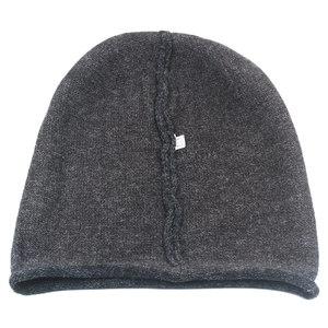 Detailed view of dark charcoal knitted beanie showing inner stitching and fabric care label