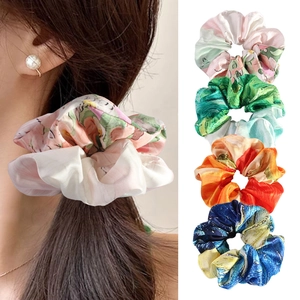 Detail view of colorful oil painting print satin scrunchies for elegant ponytail styling