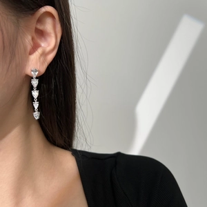 Close-up of S925 silver teardrop drop earrings with five cascading heart-shaped zircons