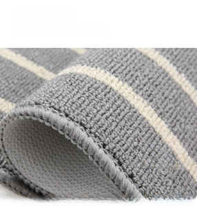 Close-up of durable loop pile texture on striped polypropylene kitchen mat with anti-slip base