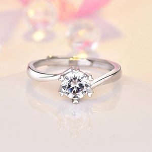 Close-up of silver ring featuring round zircon and heart-shaped six-prong setting