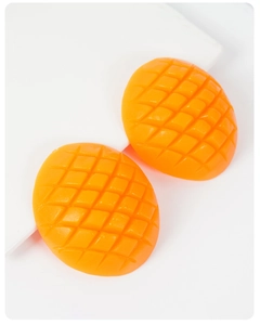 Macro detail of artificial mango chunks with realistic resin texture for cake decoration