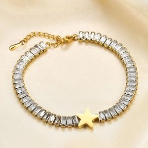Detailed close-up of a gold star bracelet with rectangular zircons on silk background