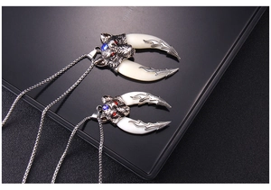 Detail view of retro stainless steel necklaces featuring wolf heads with red and blue gems