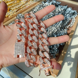 Detailed close-up of 20mm rose gold Cuban link necklace with iced-out rhinestones