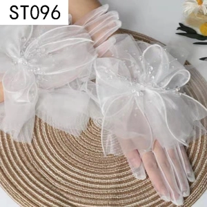Detailed view of white tulle bridal gloves featuring a large lace bow and pearl beads