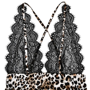 Detailed close-up of leopard print top with black lace trim and crisscross straps