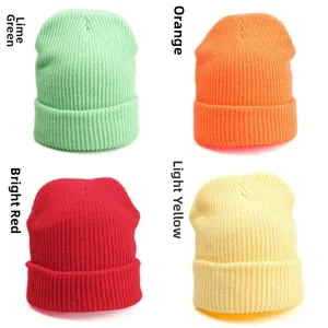 Close-up of ribbed knit beanies in green, orange, red, and yellow for autumn and winter