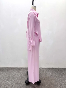 Detail of pink long sleeve shirt and trousers set with slight glossy fabric texture