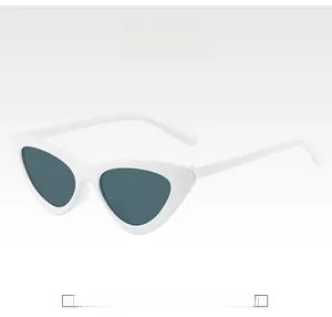Detail view of white cat-eye sunglasses frame with dark lenses in retro style