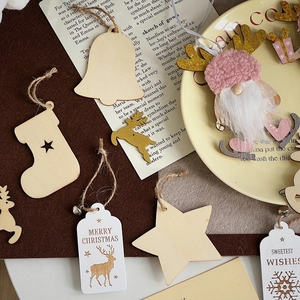 Flat lay of Christmas wooden hanging ornaments with rustic star and reindeer shapes