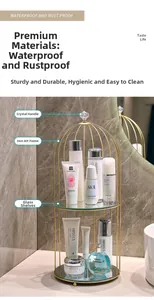 Detail of golden birdcage cosmetics rack with two-tier glass shelves and crystal handle