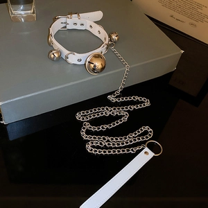 Detail of white PU leather choker with silver bells and matching chain leash accessory