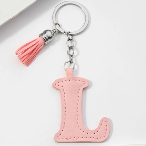 Detail of pink PU leather letter L keychain with matching tassel and silver metal ring