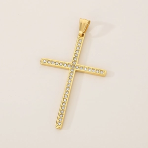 Close-up of golden hip hop cross pendant with sparkling inset stones on a white background