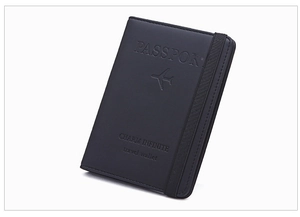 Detail view of black PU leather RFID passport holder with elastic closure band