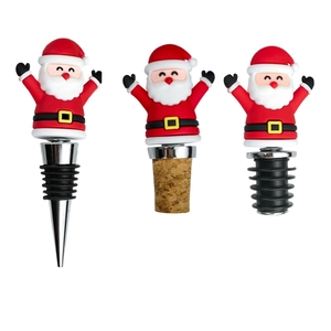 Three Santa Claus wine stoppers with metal, cork, and rubber bases on white background