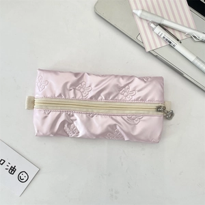 Detailed close-up of a pink quilted bow pencil case with a silver flower zipper pull
