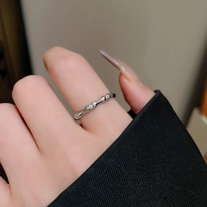 Detailed close-up of a silver bamboo joint ring with zircon accents worn on a finger