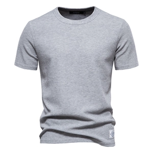 Close-up of premium grey waffle knit fabric and crew neck detail on men's cotton t-shirt