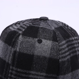 Close-up of the black and gray plaid wool fabric texture on this stylish baseball cap