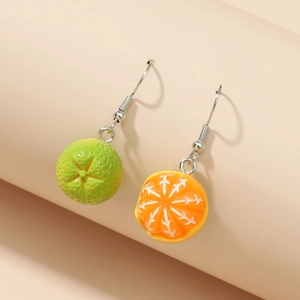 Detail shot of creative orange fruit earrings featuring textured green and citrus segments