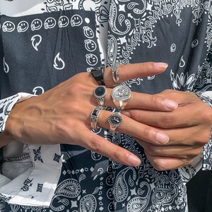 Close-up of vintage silver and black crystal stacking rings worn on model fingers