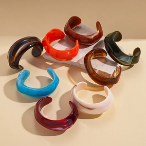 Retro geometric acrylic open bangles in marble, amber, and vibrant resin finishes