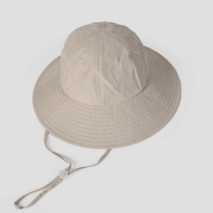 Detail of light beige sun hat with breathable fabric and adjustable chin strap